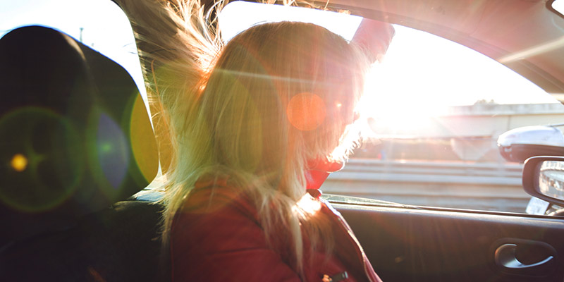 woman in car looking out window